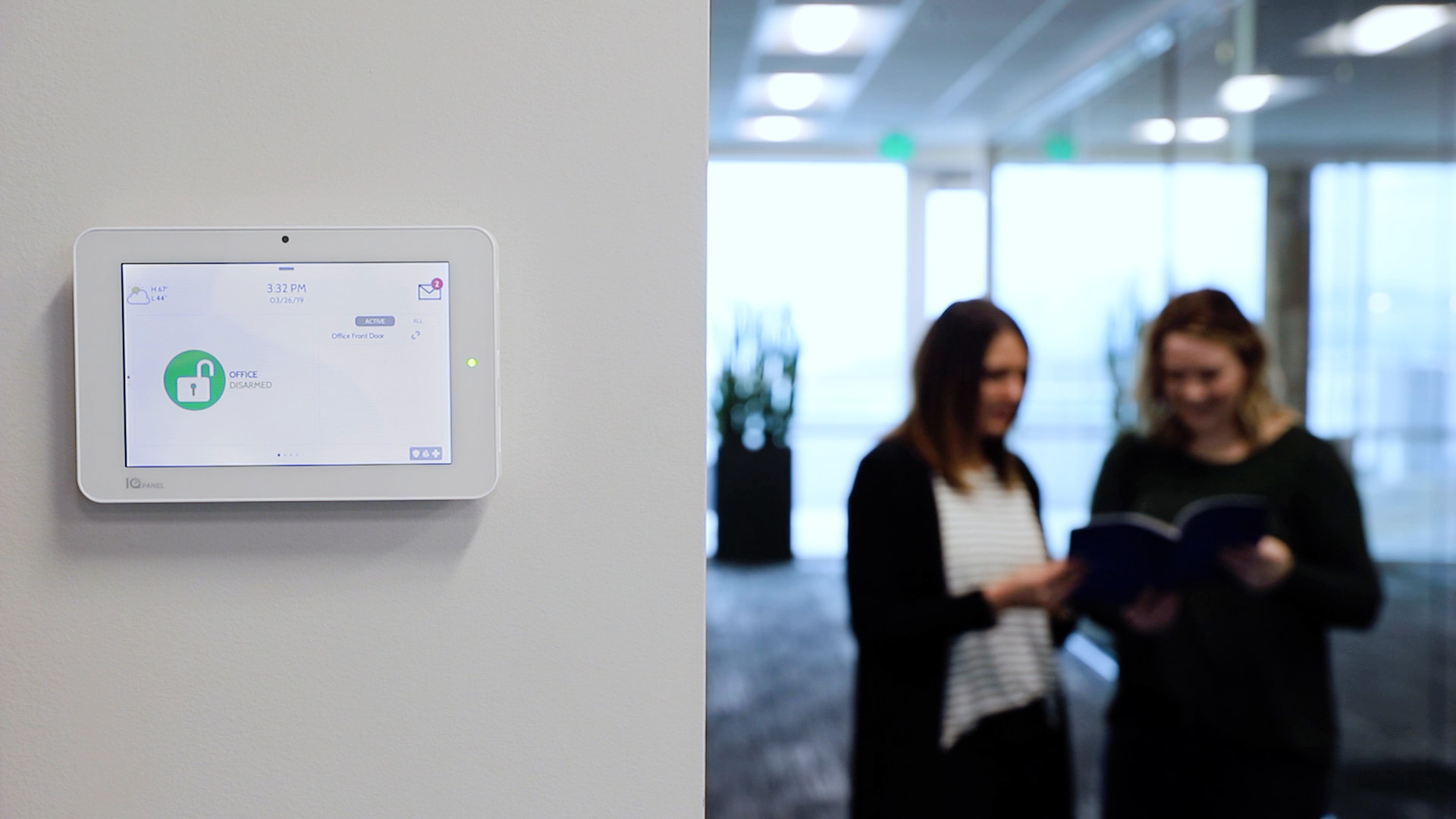 An all-in-one touchscreen security panel installed at a small business